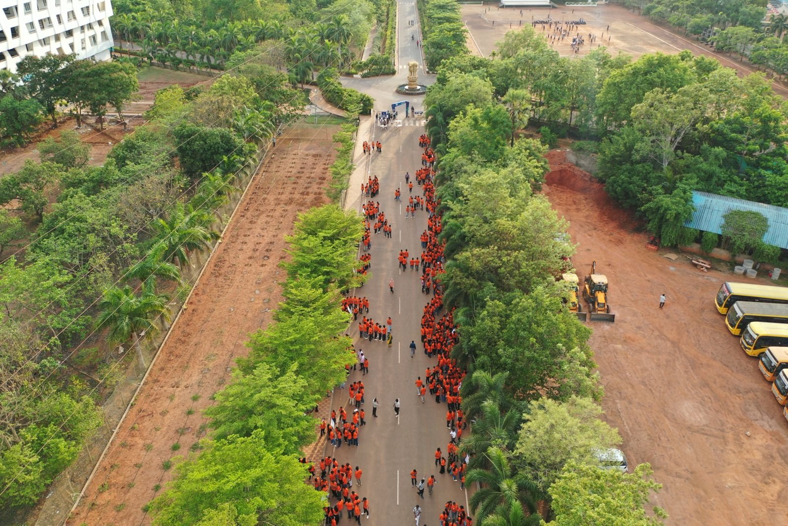 Aerial view of hundreds of students walking through the Aditya University campus