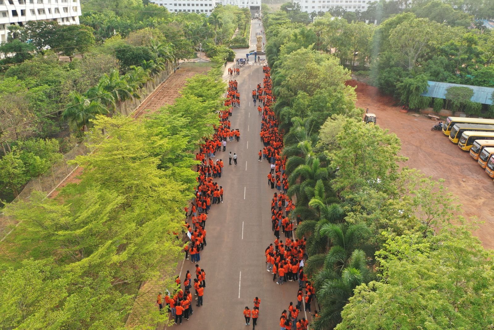 Massive crowd of students gathered along the campus avenue
