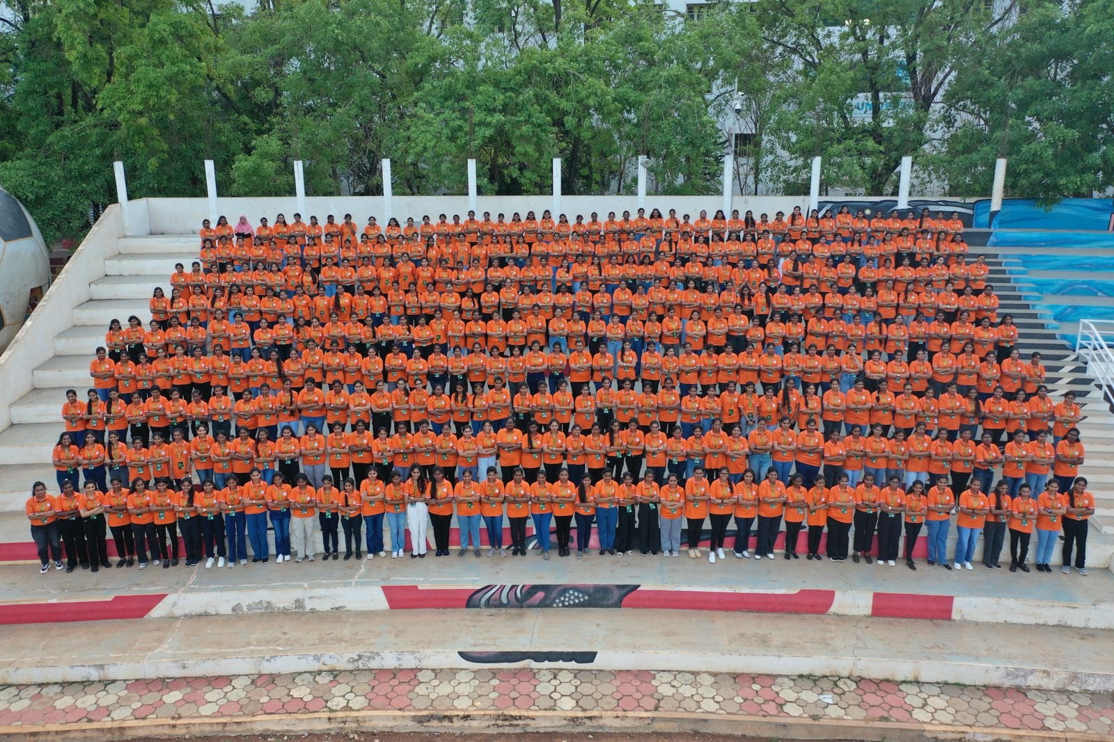 Hundreds of students seated together at the open-air amphitheatre