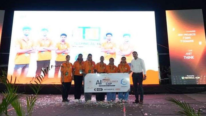 Winning team on the main stage at night receiving the AI Excellence Cap, Season 8